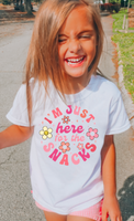 
              Little girls graphic shirt. I'm just here for the snacks print with retro flowers. 
            